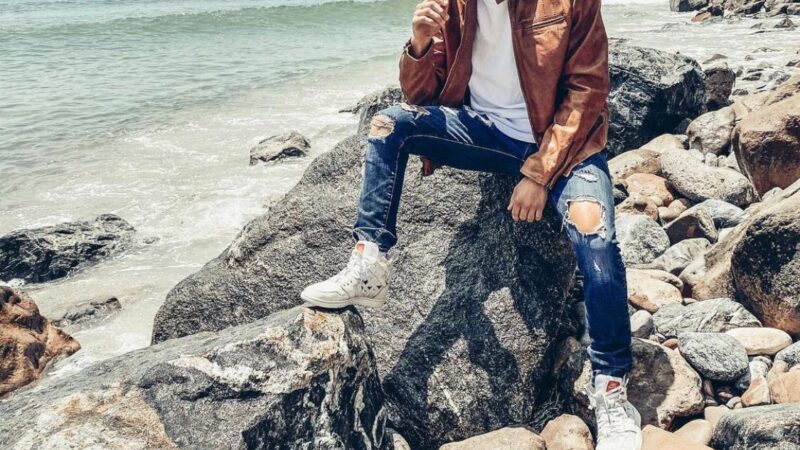 Truitt Battin rocking a John Varvatos jacket as he relaxes by the beach