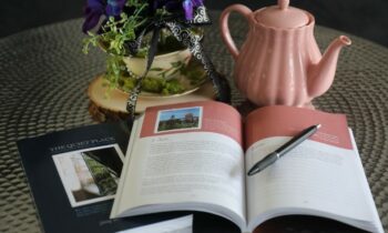 A notebook with a pen and flowers on it